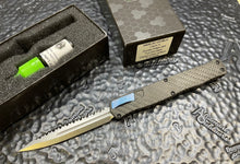 Pre-Owned Heretic Knives Cleric II - Black ANO Chassis w/ Carbon Fiber inlay, Carbon Fiber Top Cover, Stonewashed Double Edge FULL SERRATED Magnacut blade, Blue Ti Button and Blue Ti Clip  POH020-2C-CF/BLU