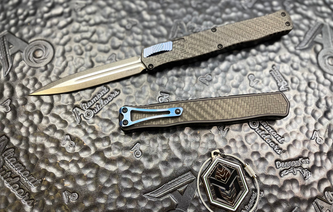 Heretic Knives Cleric II - Black ANO Chassis w/ Carbon Fiber inlay, Carbon Fiber Top Cover, Stonewashed Double Edge Magnacut blade, Blue Ti Button and Blue Ti Clip  H020-2A-CF/BLU