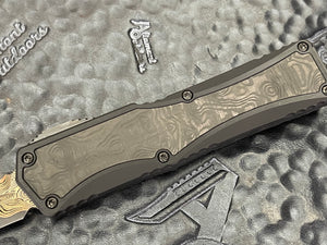 Heretic Knives Custom Colossus Hand Ground Baker Forge Damascus DE, Black ANO 6061-T6 handle w/Fat Carbon Black Dunes, DLC and FC button, DLC Satin Clip, DLC Hardware