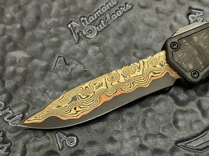 Heretic Knives Custom Colossus Hand Ground Baker Forge Damascus Recurve, Black ANO 6061-T6 handle w/Fat Carbon Black Dunes, DLC and FC button, DLC Satin Clip, DLC Hardware